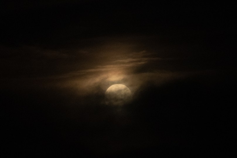 Moon emerging from the clouds